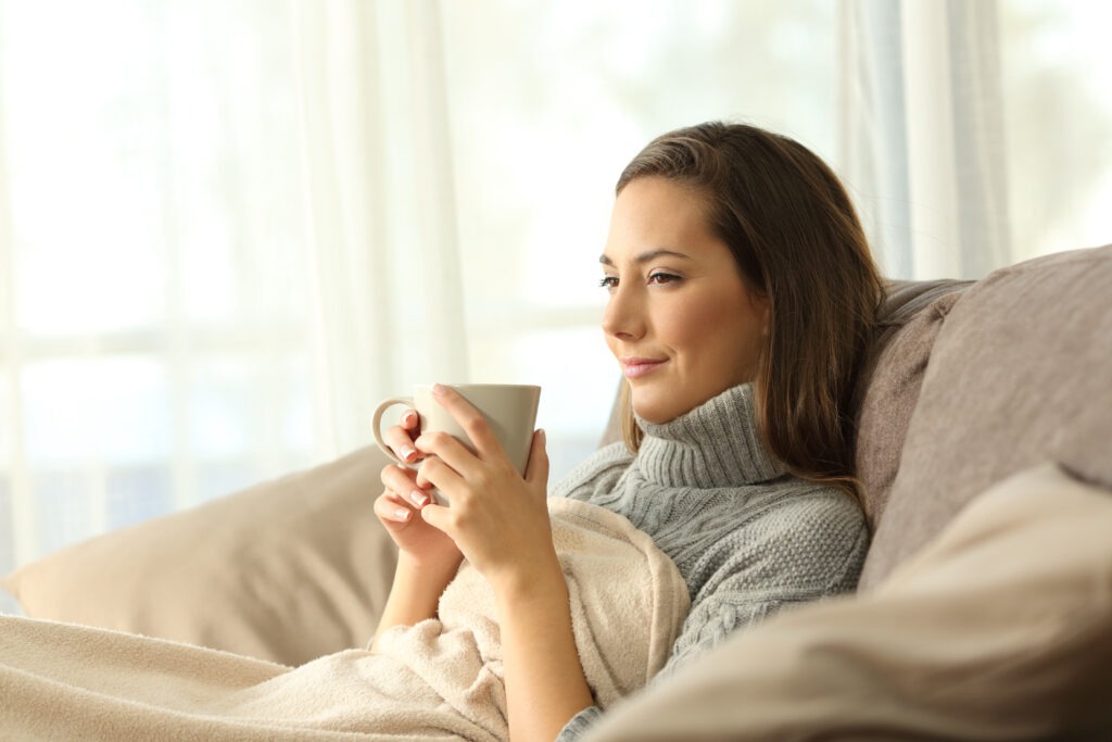 Woman rugged-up looking very comfortable.